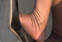 HD black nylon feet dangling shot