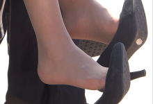 Car show girl dangling highheels on the car