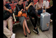 Pretty lady bare feet dangling when waiting for a train