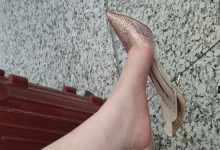 Girl in crystal heels bare feet dangling shoeplay when waiting for a train