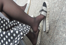 Girl in black nylon and slipper dangling shoeplay