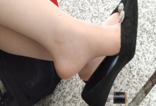 Lady dangling shoeplay when waiting for a train 43