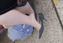 The lady dangling shoeplay when waitting for a train 39