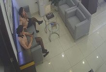 The jewelry store hostess in black nylon dangling shoeplay on the sofa