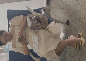 The lady in white heels dangling shoeplay when waiting for a call 12