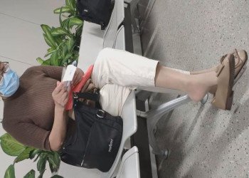 The lady in white heels dangling shoeplay when waiting for a call 13