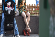 A lady in a cheongsam relax her tired feet