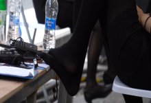 Group of models take off heels relax their tired feet 34