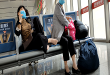 Lady remove heels relax her tired feet when line up in the waiting hall 