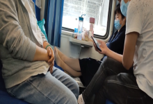 The lady take off her shoes on the train