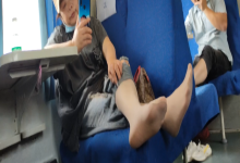 The lady take off her shoes on the train 2