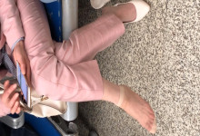 The lady remove shoes relax her tired feet when waitting for a train 34