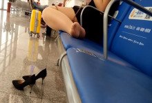 The lady remove shoes relax her tired feet when waitting for a train 35