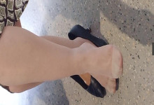 The lady relax her tired feet when line up in the waiting hall 108