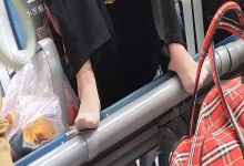 The middle-age lady relax her tired feet when waiting for a train 8