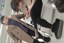 The lady relax their tired feet when line up in the waiting hall 179