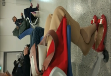 The lady relax her tired feet when line up on the waiting hall 180