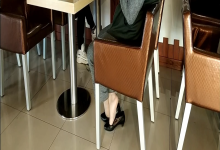 Lady shoeplay under the table when having lunch