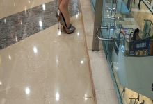 Shopping mall catch girl stand up dipping and shoeplay in silver heels