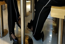 Black nylon feet dipping and shoeplay under the table 