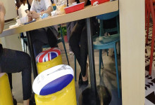 The lady dangling shoeplay under the table when having lunch 20