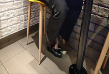 The lady dangling shoeplay under the table when having lunch 22