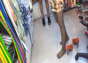 The hot girl buying shoes in the shoe store