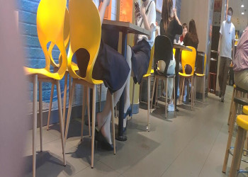 The girls dipping shoeplay under the table when having lunch 4