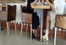 The girl dangling shoeplay under the table when having lunch 24