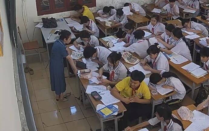 The teacher in blue dress and white heels dipping shoeplay when having a lesson