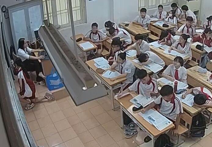 Under the chandelier we saw the teacher take off his shoes