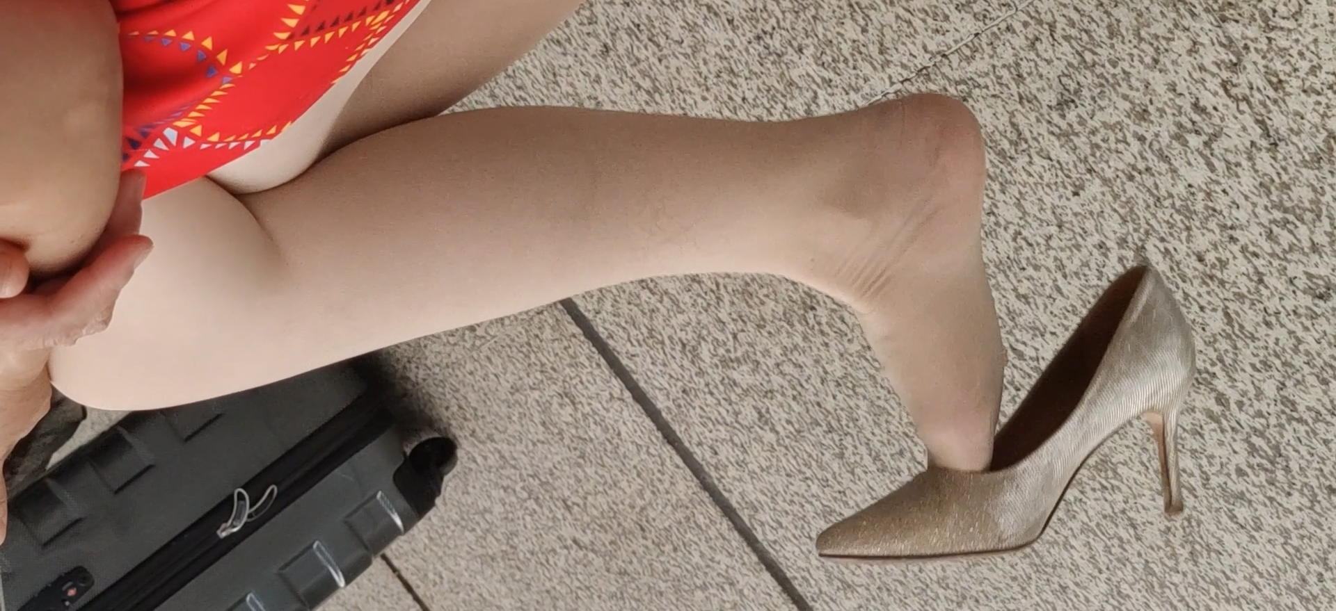Lady dangling shoeplay when waiting for a train 27