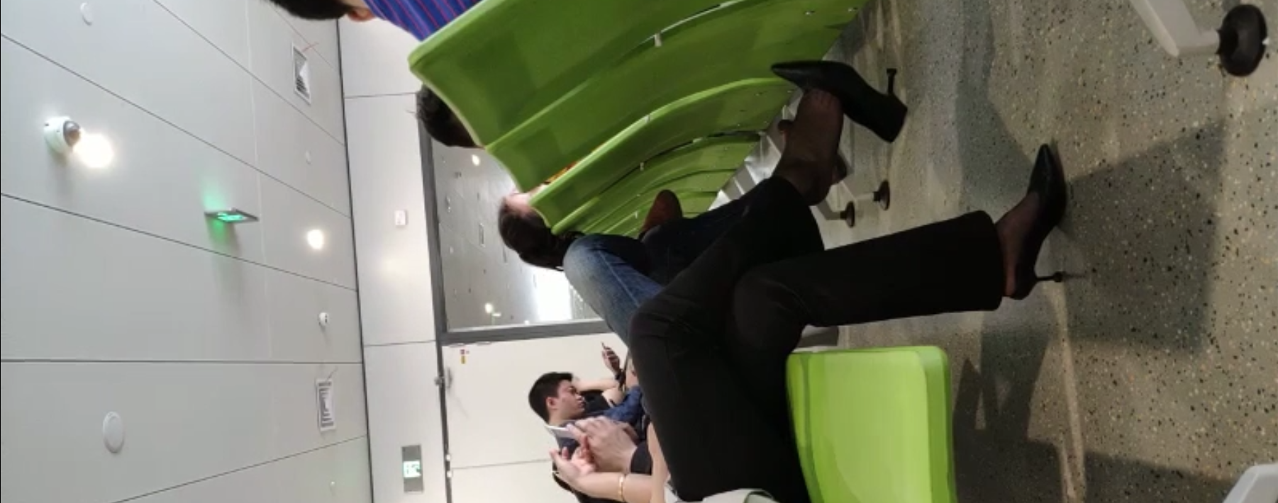 Lady dangling shoeplay when line up in the waiting hall 84