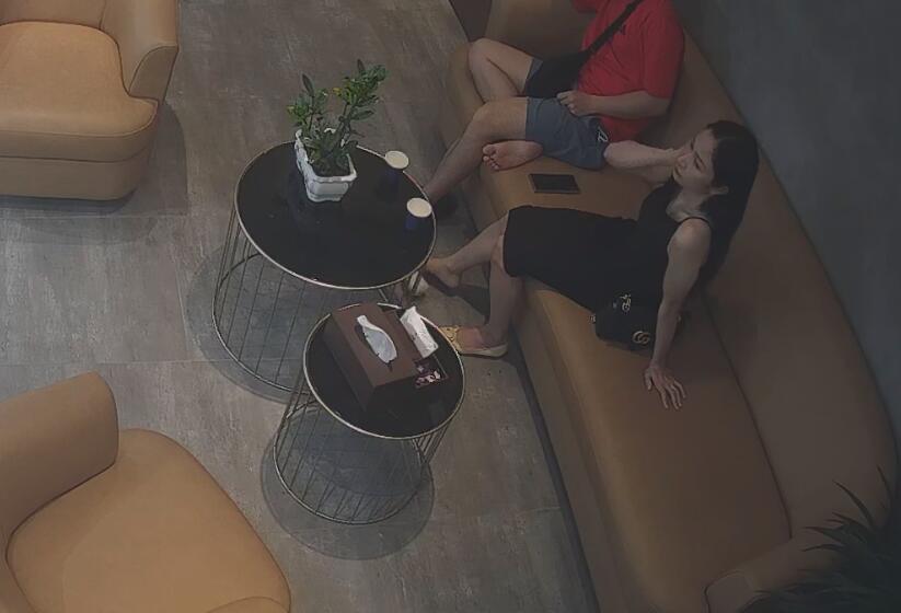The pretty   consumer dangling shoeplay on the sofa