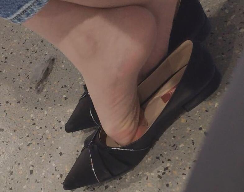 The lady in black heels dangling shoeplay when waiting for a call 9