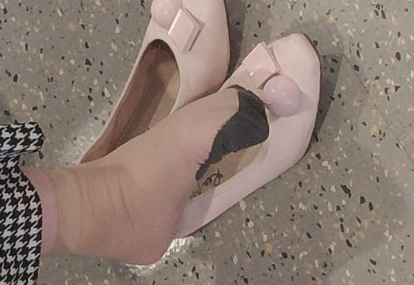 The beautiful woman in  special pattern stockings dangling shoeplay