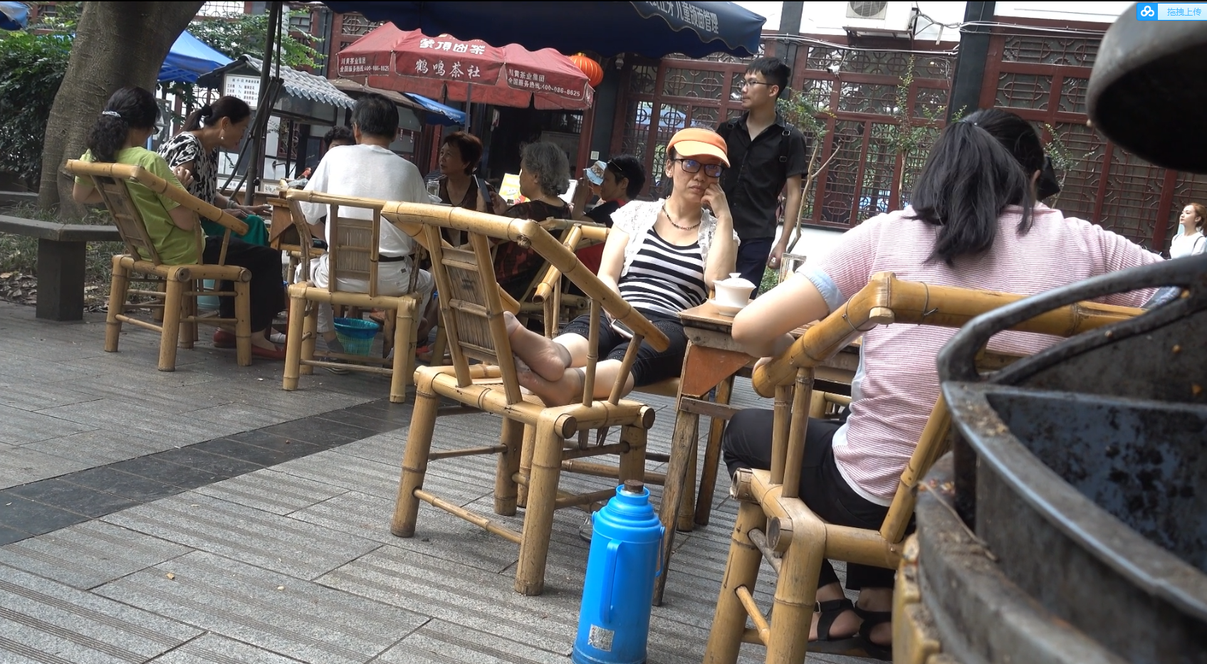 The lady with the glasses relax her feet
