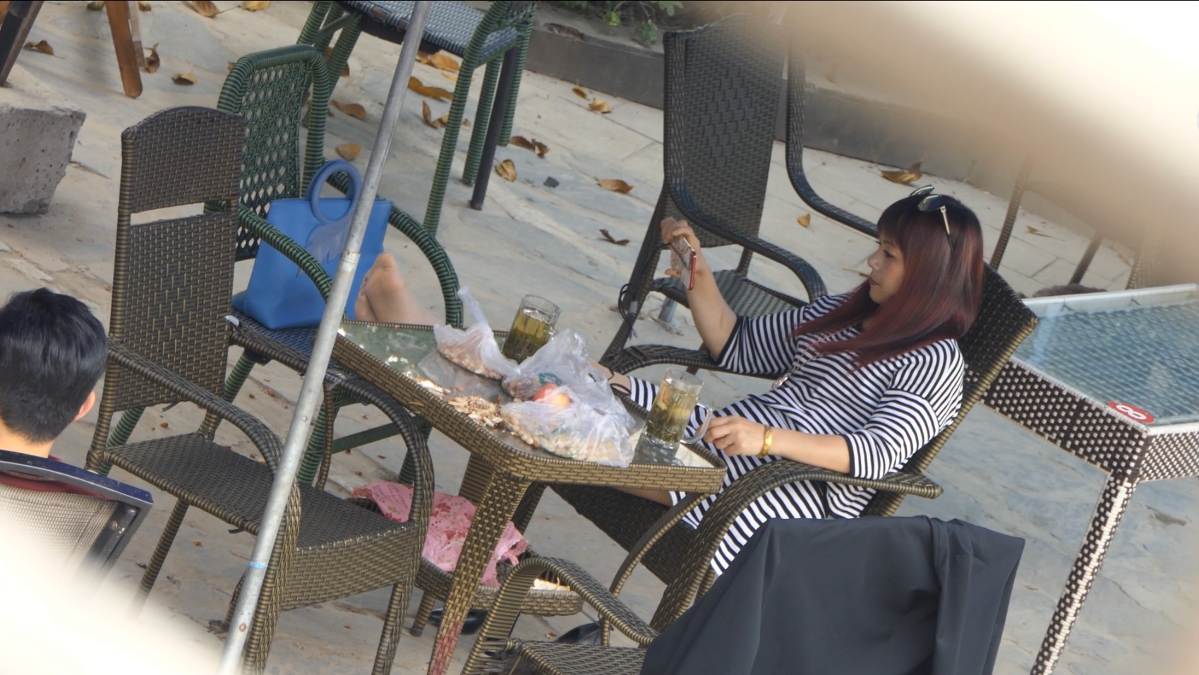 Pretty lady play cell phone on the chair