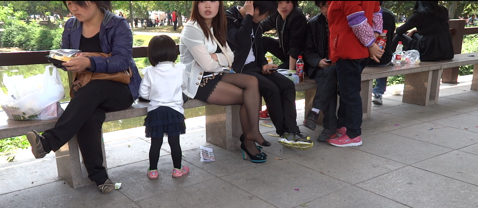 Girl in  mini-skirt and black nylon feet massage by herself