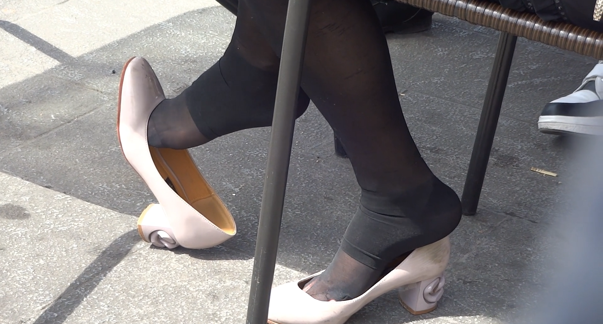 Girl in foot tights white heels  dangling and shoeplay