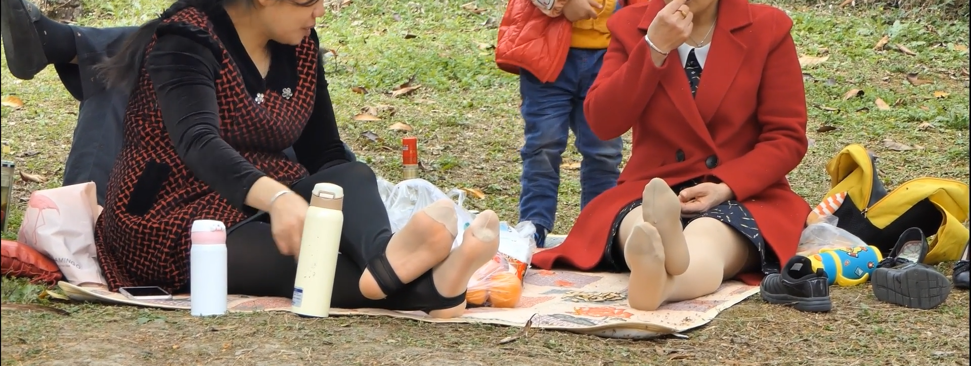 Lady in stirrup trousers relax her sexy feet in the park