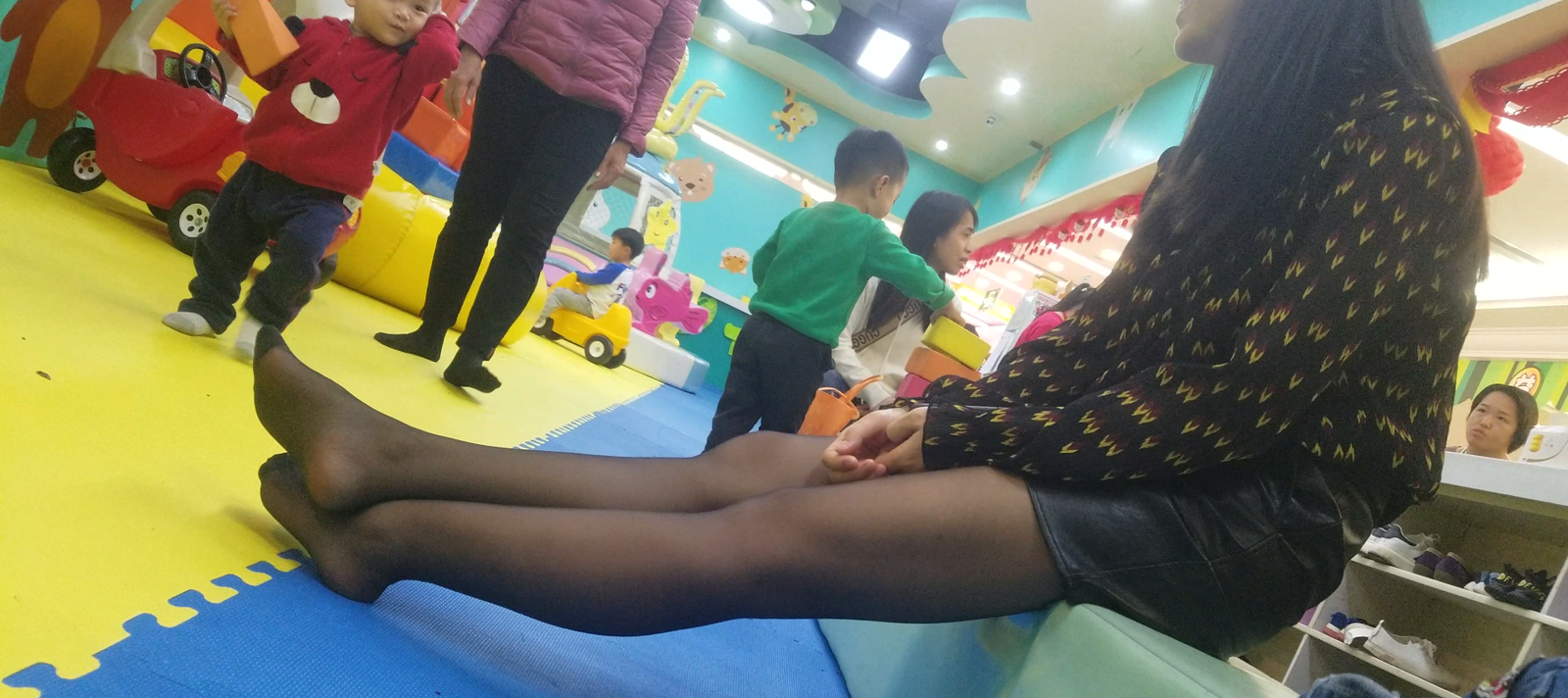 Children's recreation centre young mother's sexy black nylon feet