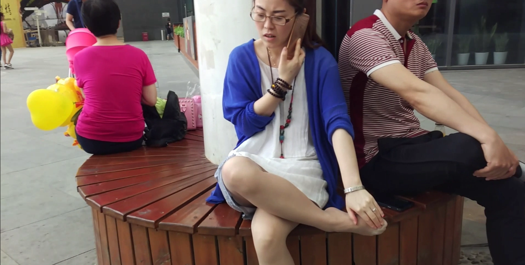 Lady sit down footmassage by herself when on the phone