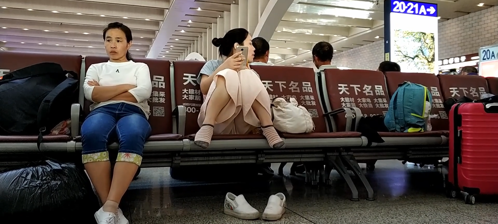 Lady remove shoe and relax her tired feet on the chair when waiting for a train 23