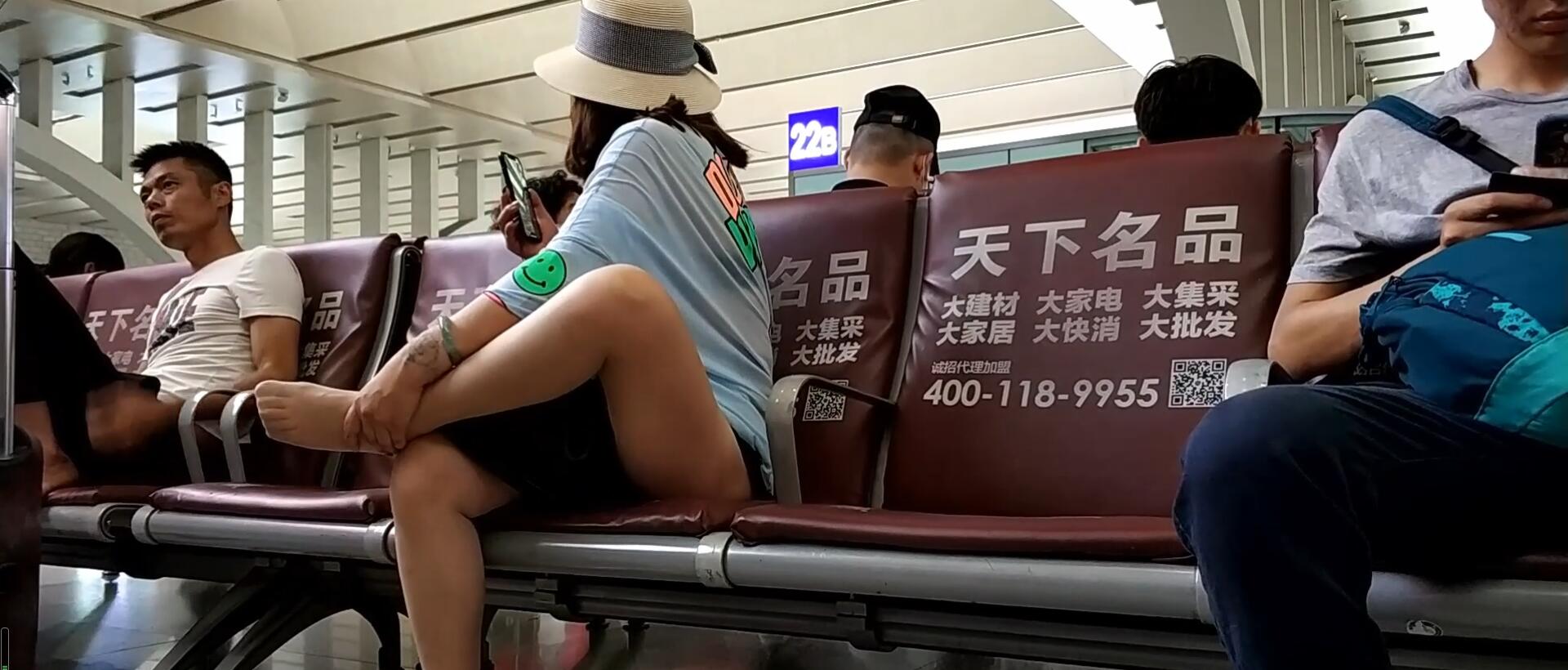 Lady remove shoe and relax her tired feet on the chair when waiting for a train 29