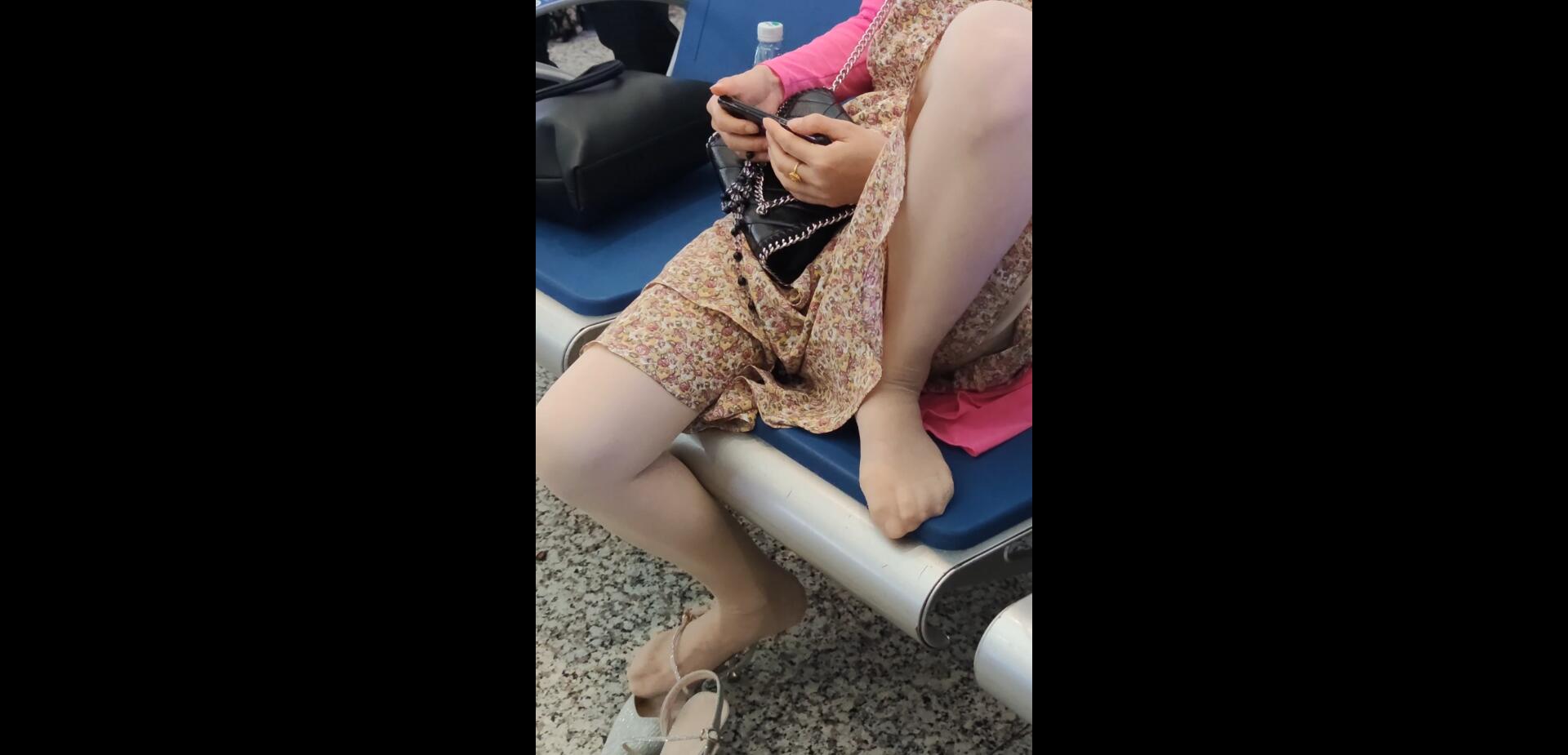 Lady remove shoe and relax her tired feet on the chair when waiting for a train 32