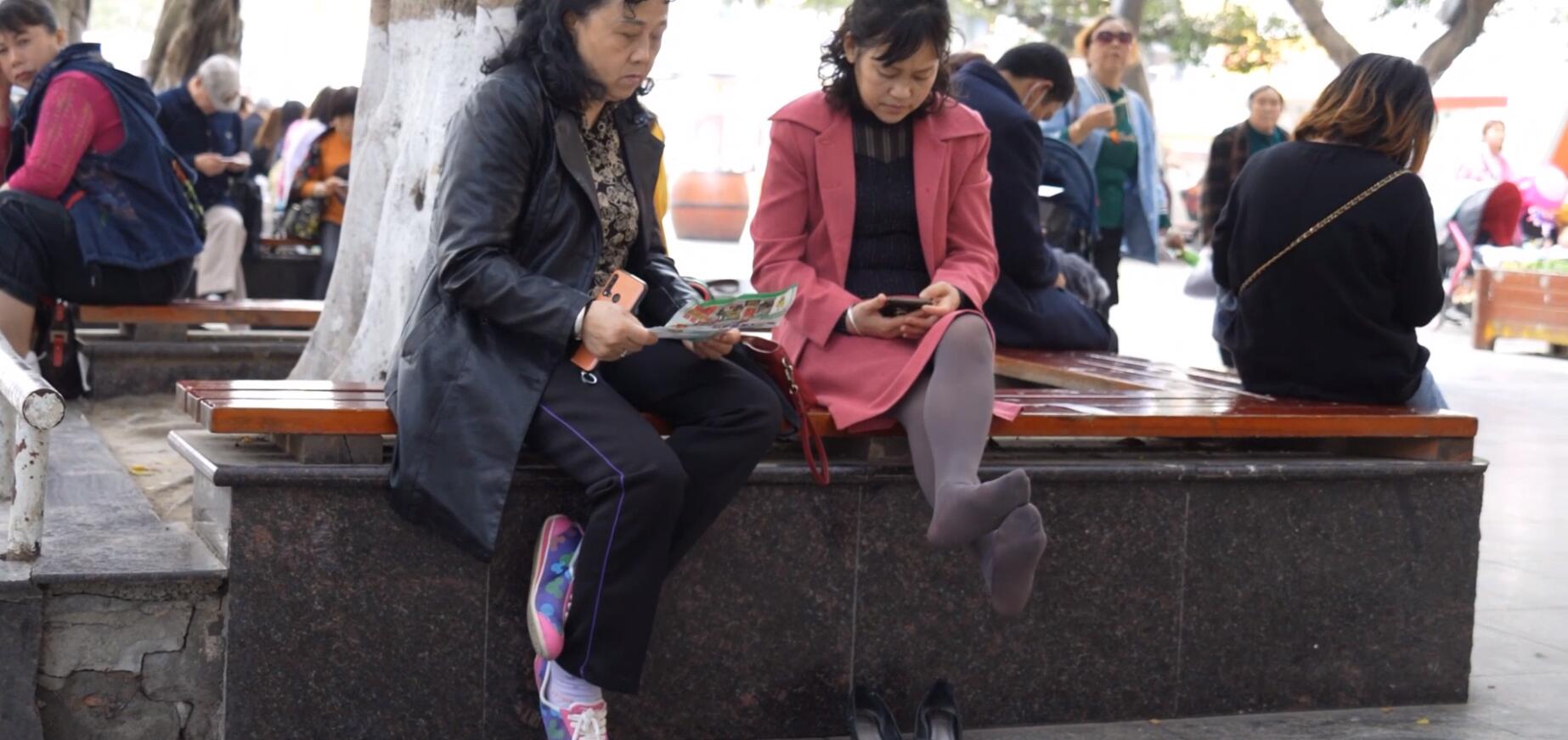 The middle age lady&#039;s remove heels relax her brown nylon feet