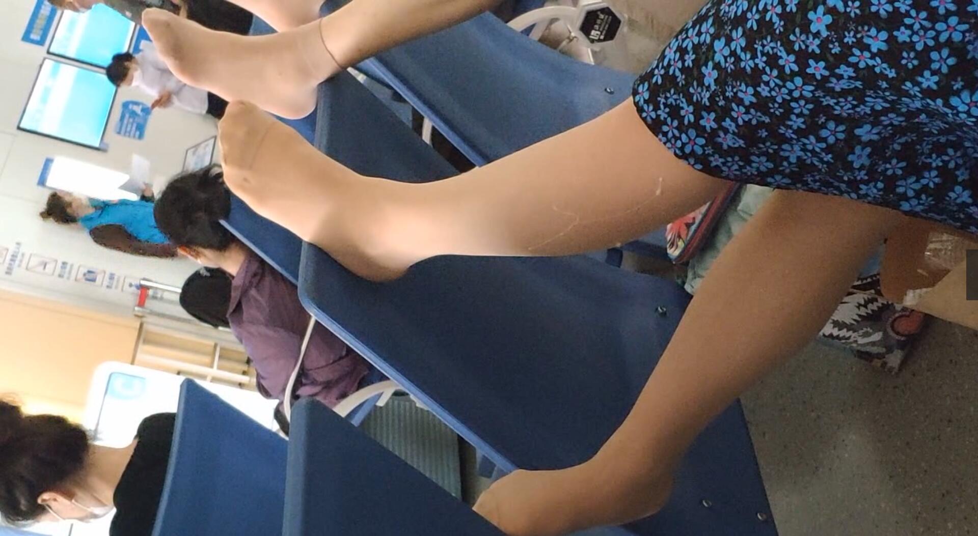 The lady relax her tired feet when line up in the waiting hall 105