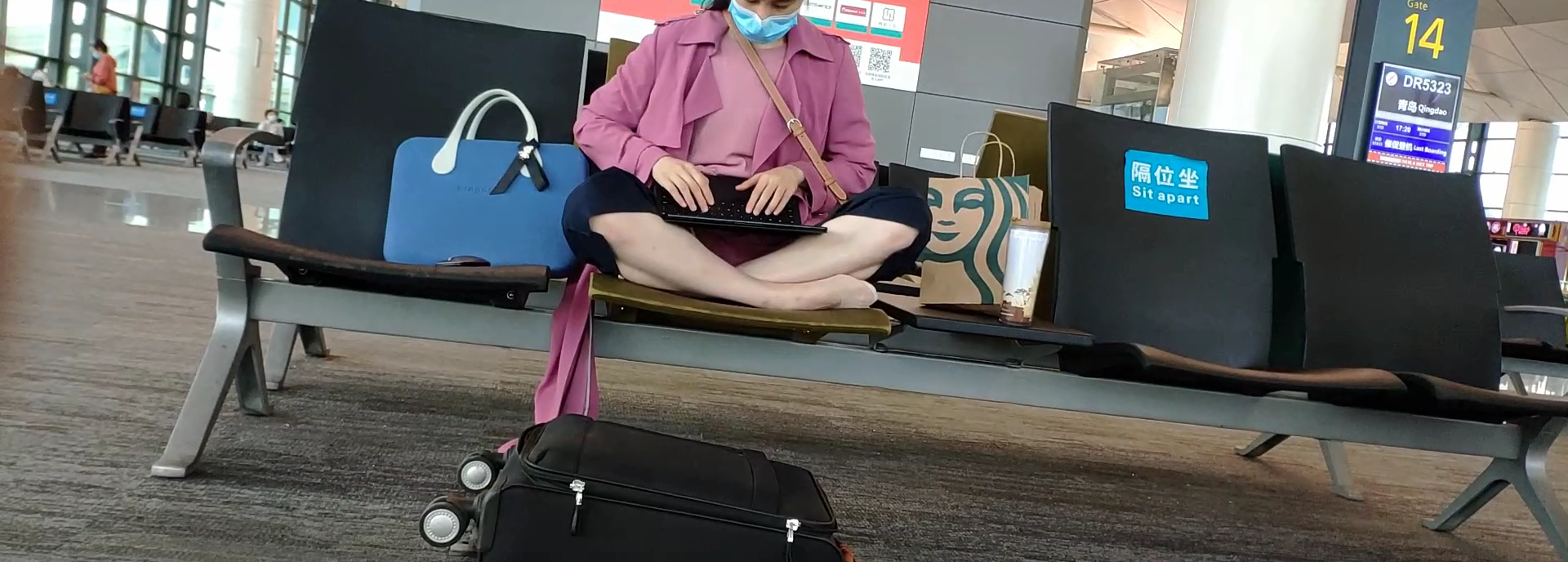 The lady relax her tired feet when waiting for the airline 