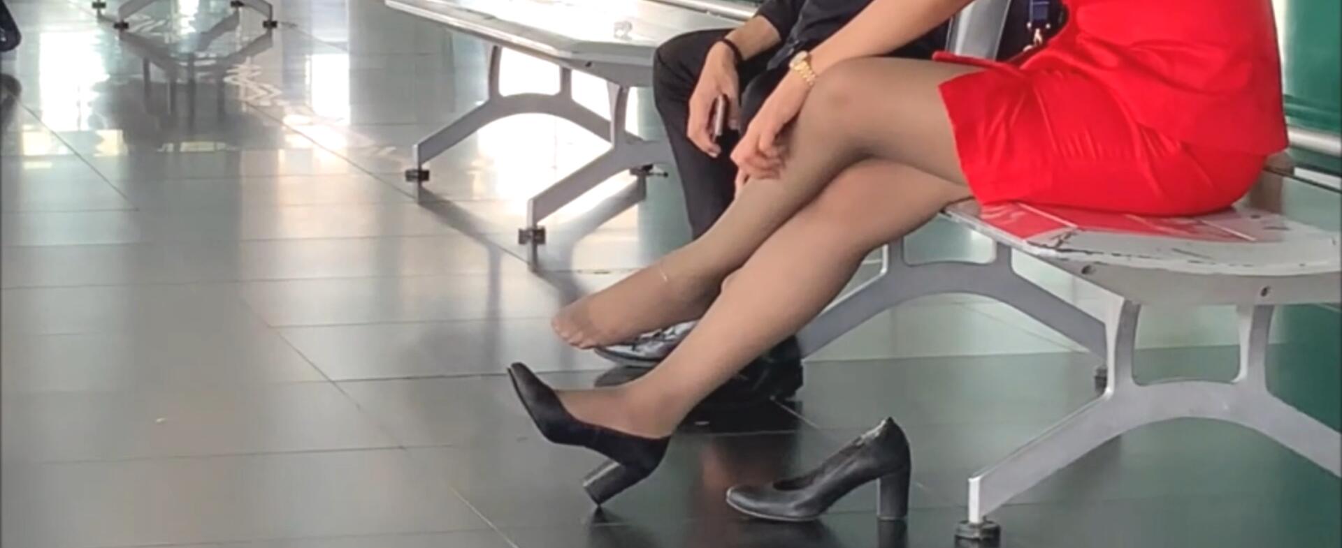 The hot lady in red dress take off heels relax her feet